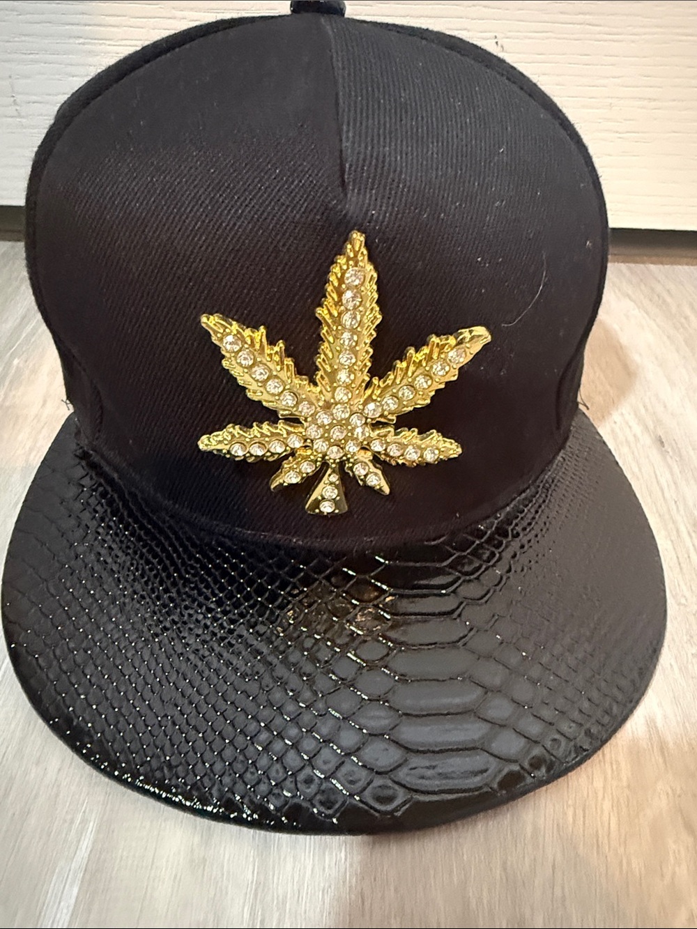 Black Men's Snapback Hat with Gold Leaf Embellishment
